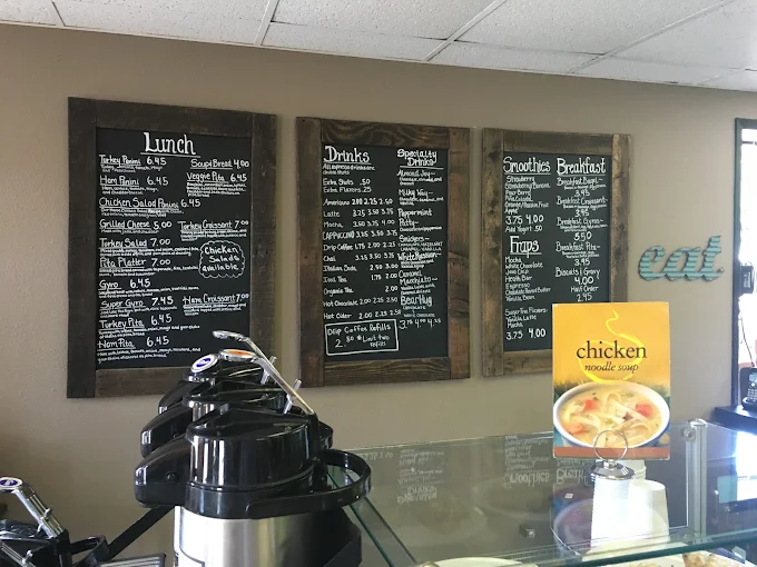 Three chalkboard menu panels at The Grind showing drinks, lunch, and breakfast options